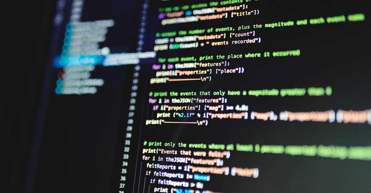 Program code on a monitor in a dark room.